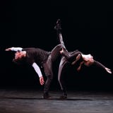 Two dancers of RUBBERBAND perform together.